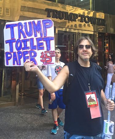 Protestor outside of Trump Tower in New York City with item to handle dung spread by The Donald. LBW Photo